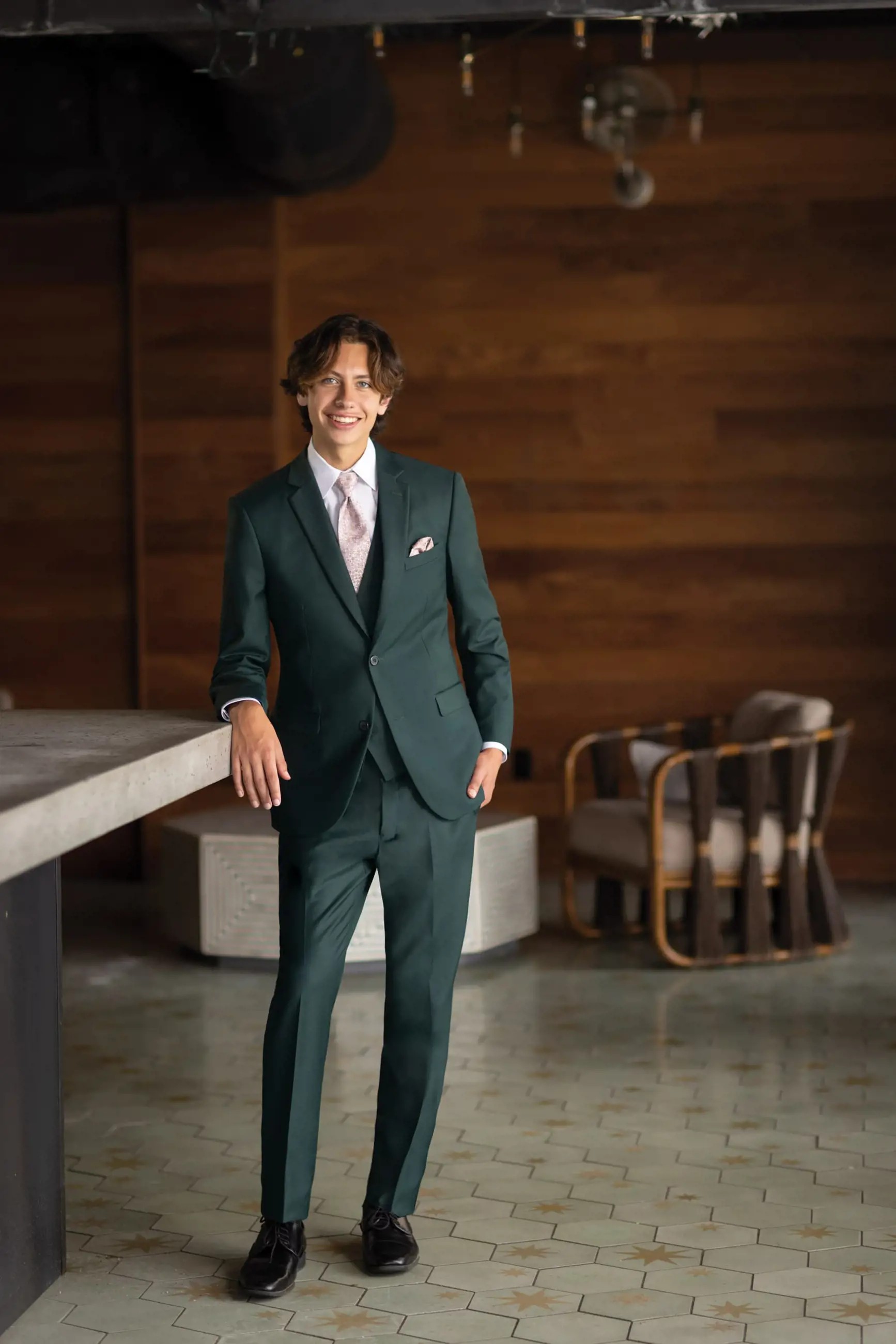 Model wearing a dark-green suit