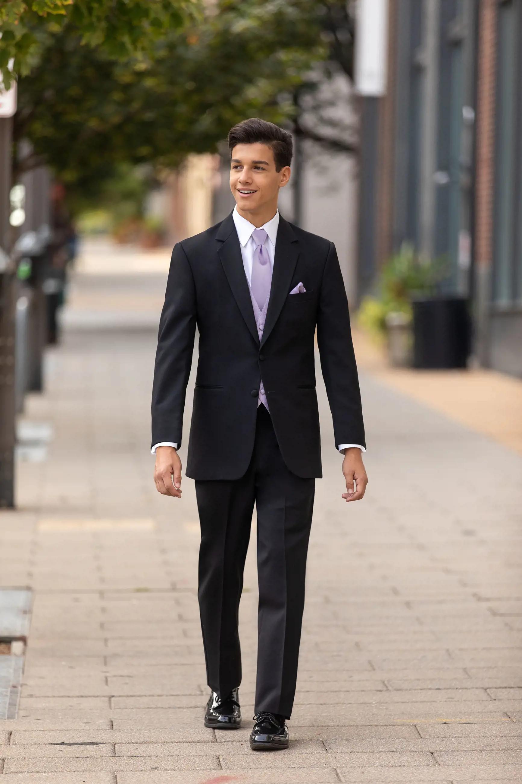Model wearing a black suit at the street