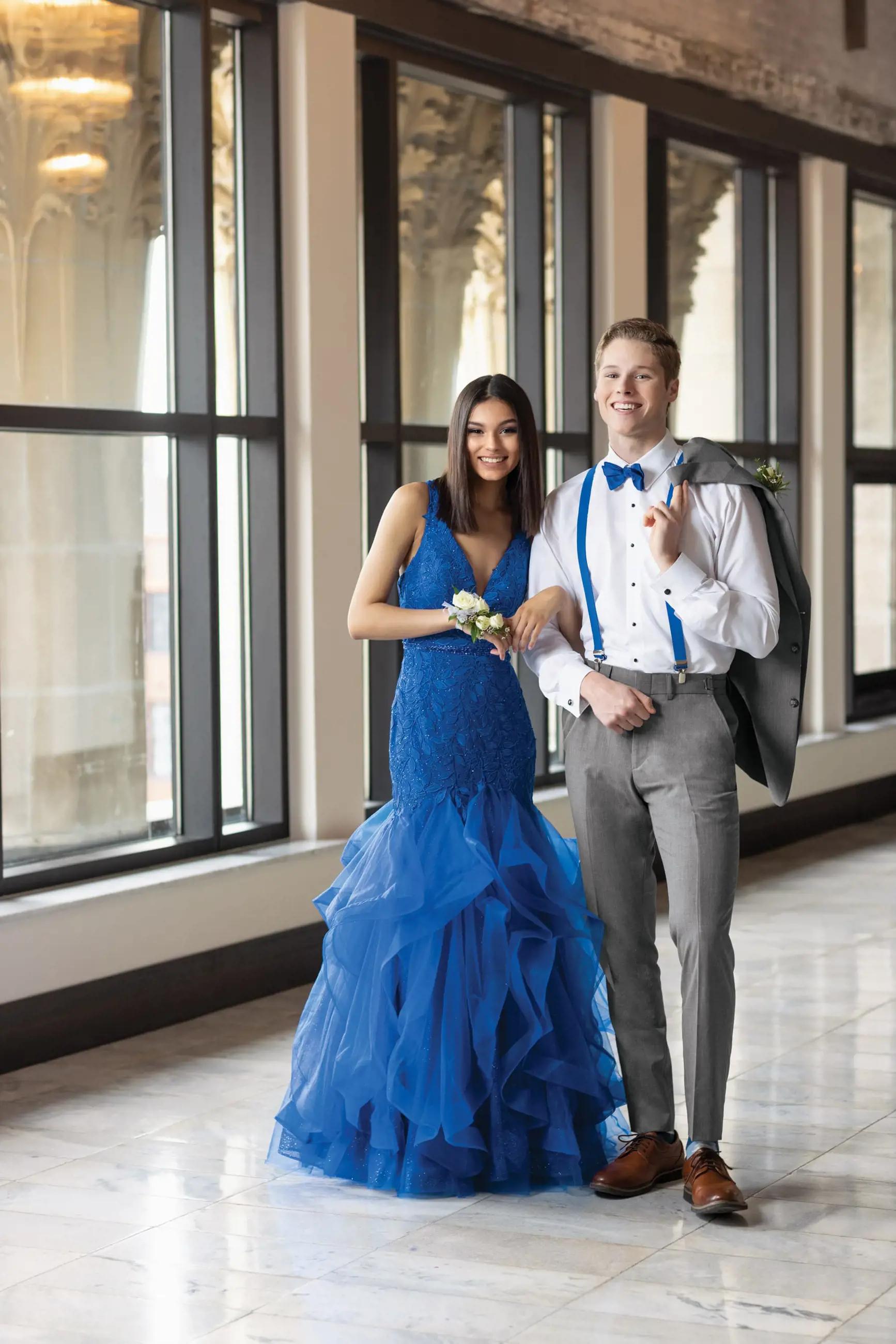 Сouple wearing a blue gown and a gray suit