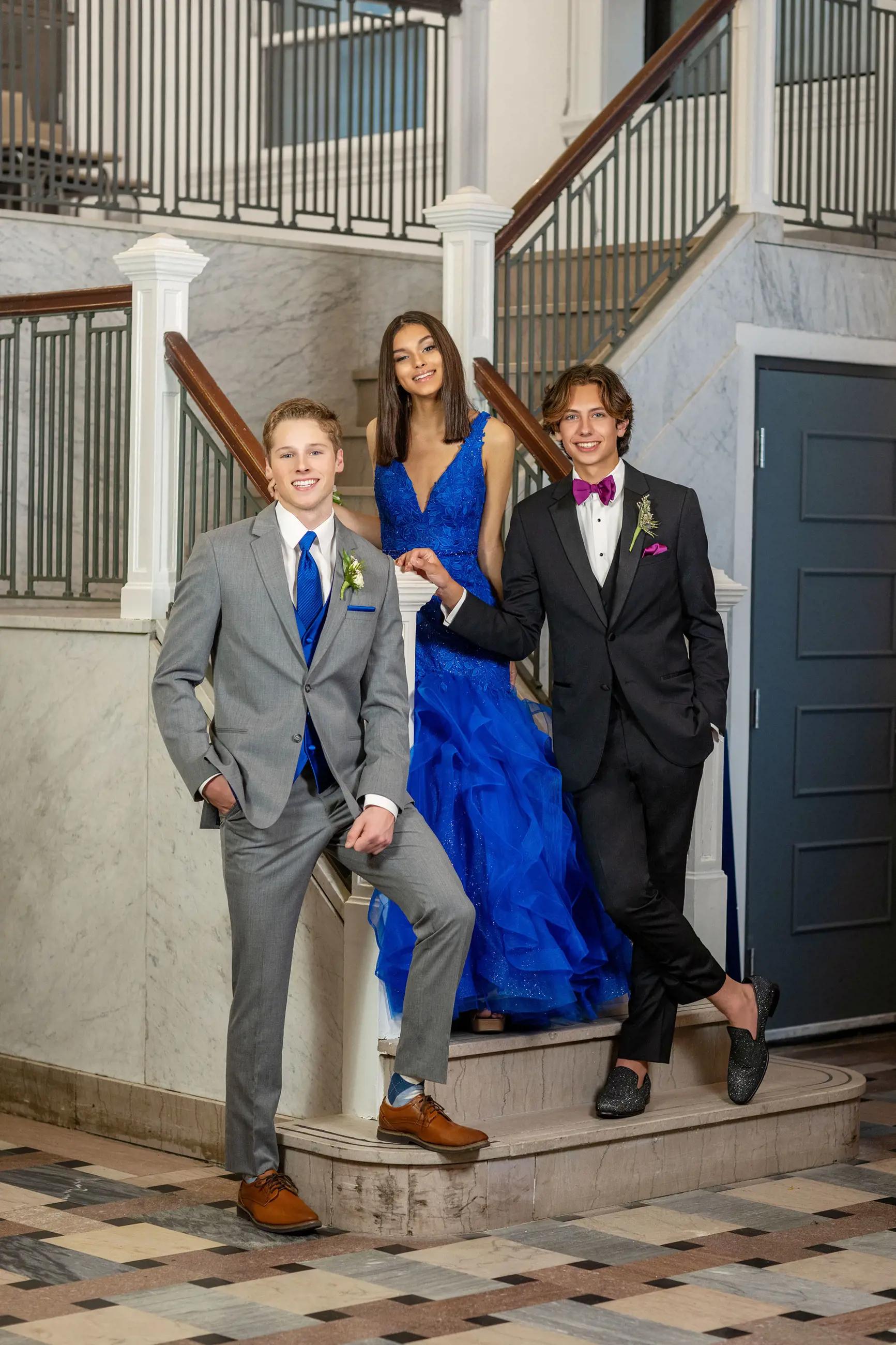 Models wearing a blue dress, gray and black suits
