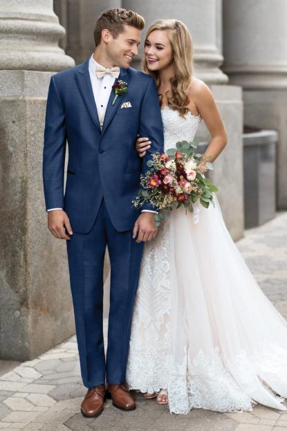 Сouple wearing a white gown and a blue suit